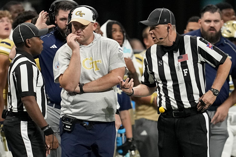 Georgia Tech head coach Brent Key speaks with officials during the first half of an NCAA college football game against Louisville, Friday, Sept. 1, 2023, in Atlanta. (AP Photo/Mike Stewart)