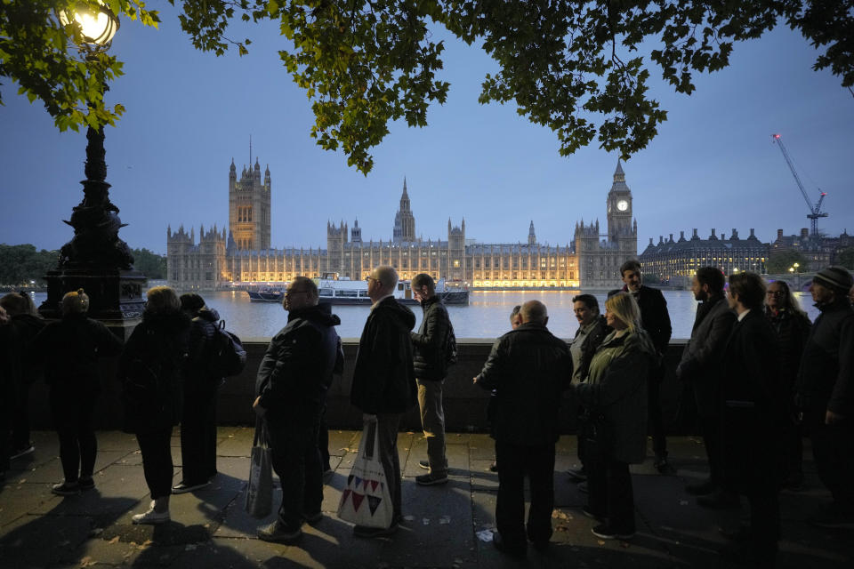 People queue to pay their respect to the late Queen Elizabeth II during the Lying-in State, at Westminster Hall in London, Thursday, Sept. 15, 2022. The Queen will lie in state in Westminster Hall for four full days before her funeral on Monday Sept. 19. (AP Photo/Markus Schreiber)