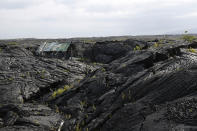 <p>A structure is seen atop the 1990 lava flow from Kilauea, one of the world’s most active volcanoes, Sunday, May 6, 2018, in Kalapana, Hawaii. (Photo: Marco Garcia/AP) </p>