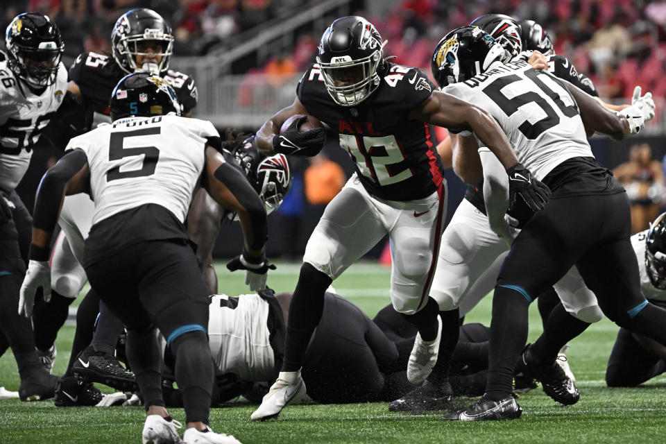 Atlanta Falcons running back Caleb Huntley (42) runs against Jacksonville Jaguars safety Rudy Ford (5) during the first half of an NFL football game, Saturday, Aug. 27, 2022, in Atlanta. (AP Photo/Danny Karnik)