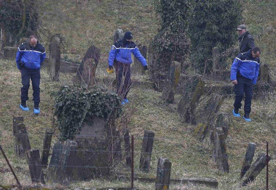 French gendarmes investigate near desecrated tombstones at the Sarre-Union Jewish cemetery, eastern France