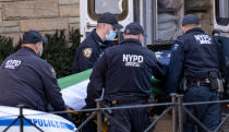 The remains of New York City Police Department Officer Wilbert Mora arrives at a funeral home in the Manhattan borough of New York, Wednesday, Jan. 26, 2022. Officer Mora, who died Tuesday, was gravely wounded last week in a Harlem shooting that also killed his partner. (AP Photo/Craig Ruttle)