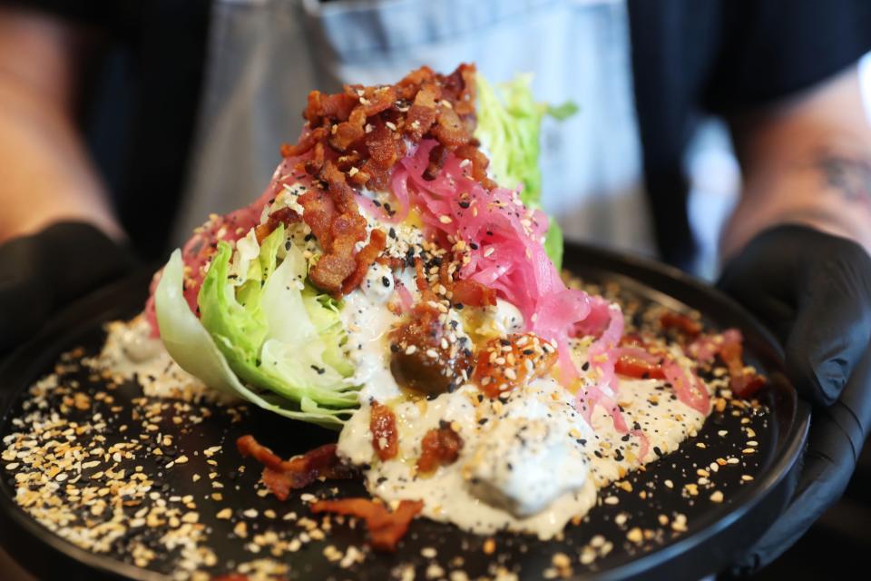 Chef Harrison Downing displays the Wedge Salad at Greys Fine Cheeses and Entertaining in Memphis.