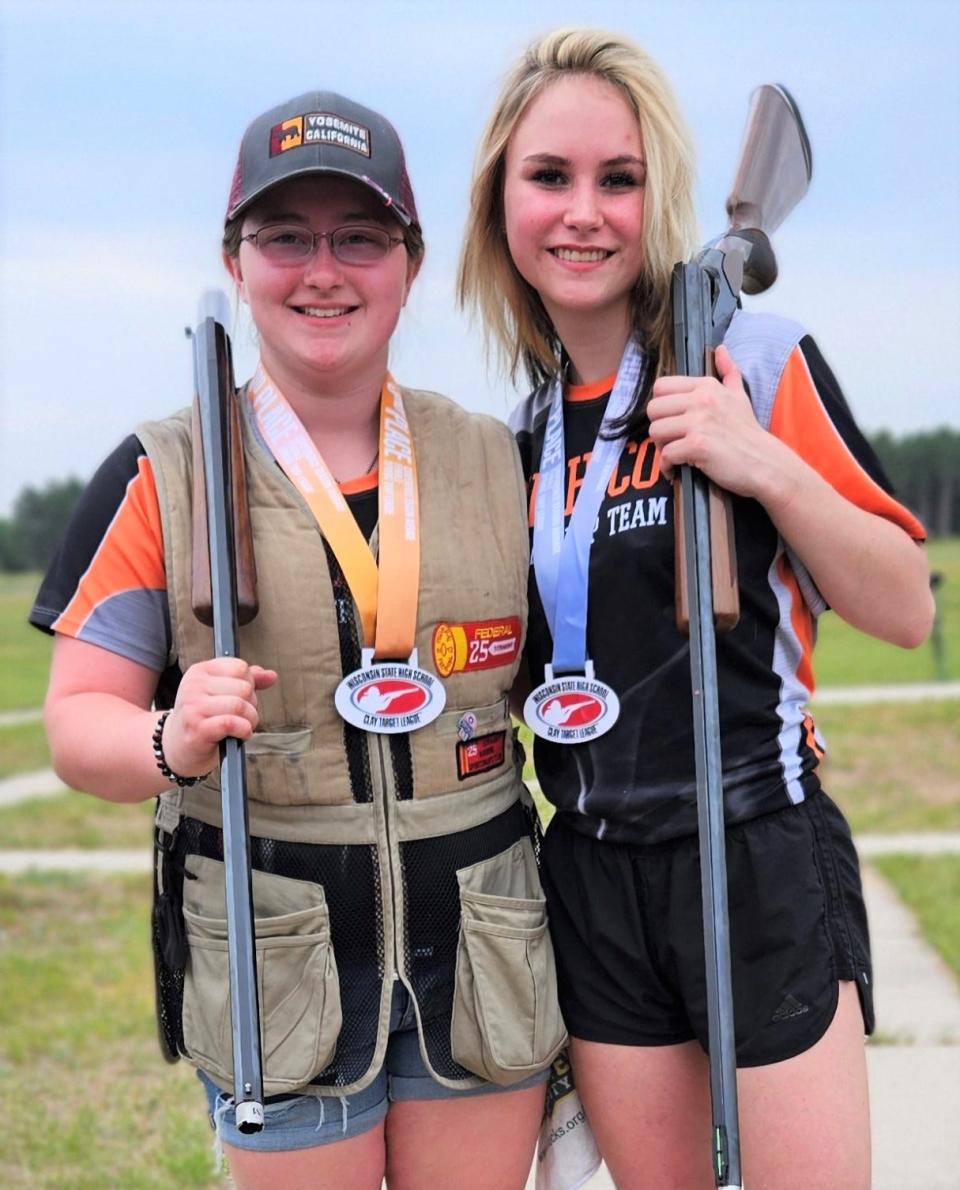 Mishicot High School trap shooter Emma Schmidt (from left) shows her third-place medal with Vanessa Paquette showing her second-place medal in conference. Both girls will soon be competing in the National High School Trap Tournament in Mason, Michigan.