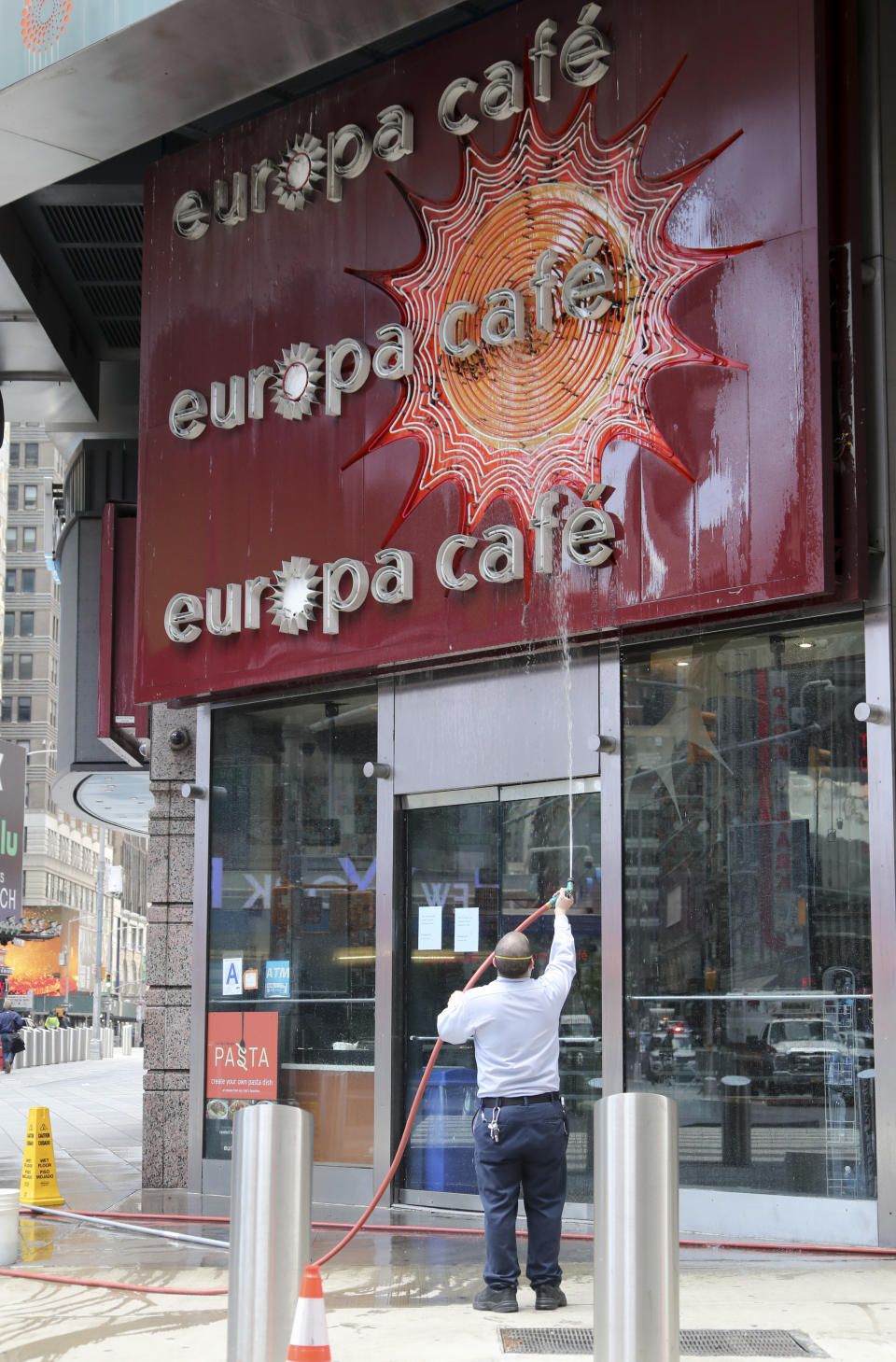 NEW YORK, May 4, 2020 -- A worker cleans a cafe's signboard at Times Square in New York, the United States, May 4, 2020. Amid the ongoing COVID-19 pandemic, New York Governnor Andrew Cuomo on Monday outlined additional guidelines regarding when regions can reopen. According to the Governor's Press Office, the state will monitor four core factors to determine if a region can reopen: number of new infections, health care capacity, diagnostic testing capacity and contact tracing capacity. (Photo by Wang Ying/Xinhua via Getty) (Xinhua/Wang Ying via Getty Images)