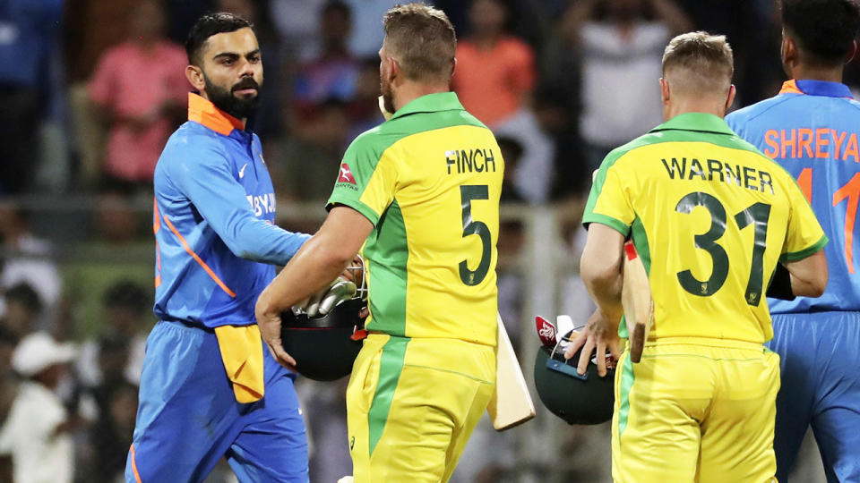 Virat Kohli, pictured here congratulating the Aussies after the first ODI on Tuesday in India.