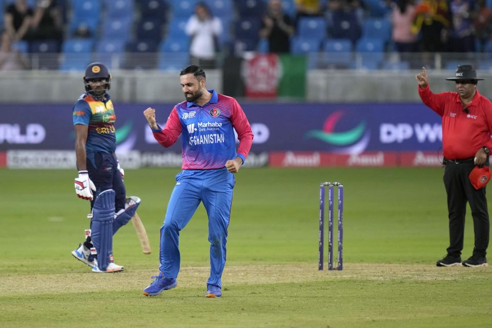 Afghanistan's Mohammad Nabi, center, celebrates after taking the wicket of Sri Lanka's Dasun Shanaka during the T20 cricket match of Asia Cup between Afghanistan and Sri Lanka, in Dubai, United Arab Emirates, Saturday, Aug. 27, 2022. (AP Photo/Anjum Naveed)