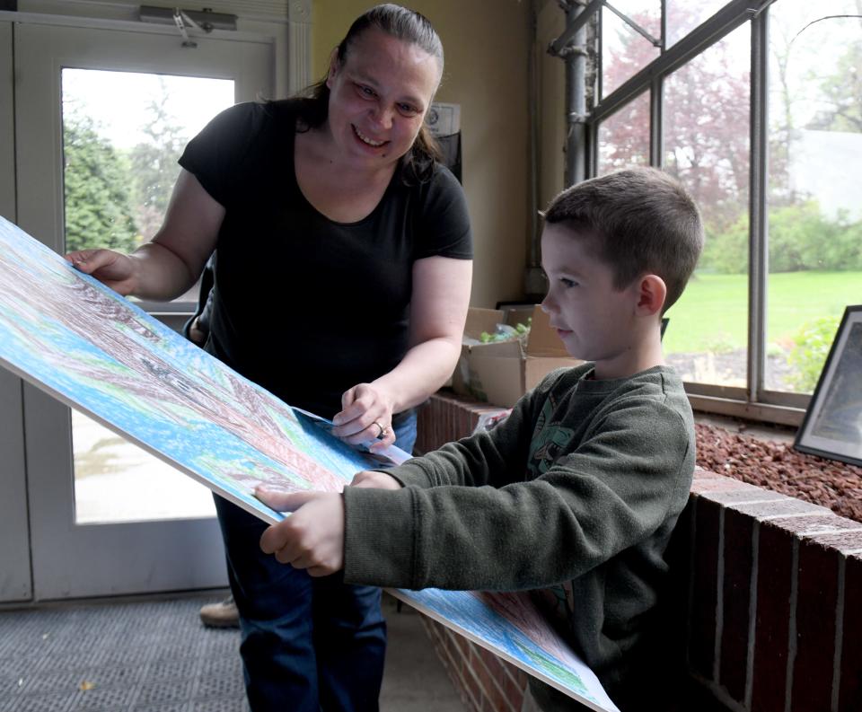 Jean-Ann Elefterin talks with son, James Elefterin, 7, a Summit Arts Academy second grade student who won this year's poster contest for Canton's 10th annual Arbor Day Celebration at the Canton Garden Center. The event was present by Canton City, the Canton Tree Commission and Canton Parks & Recreation.