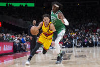 Atlanta Hawks guard Trae Young (11)drives past Boston Celtics center Robert Williams III (44) during the second half of an NBA basketball game Friday, Jan. 28, 2022, in Atlanta. (AP Photo/Hakim Wright Sr.)