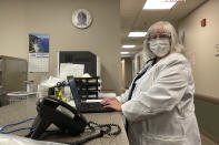 Dr. Sara Goza looks over while working at First Georgia Physician Group Pediatrics in Fayetteville, Ga., Tuesday, Aug. 17, 2021. The vaccinations that U.S. schoolchildren are required to get to hold terrible diseases like polio, hepatitis, tetanus and whooping cough in check are way behind schedule this year, threatening further complications to a school year already marred by COVID-19. (AP Photo/Angie Wang)