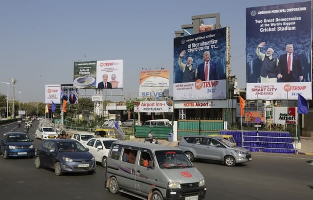 Vehicles drive past billboards welcoming  Donald Trump in Ahmedabad