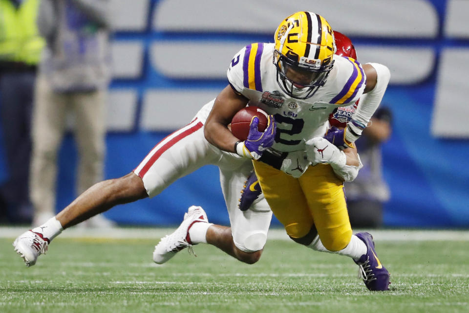 FILE - In this Dec. 28, 2019, file photo, LSU wide receiver Justin Jefferson (2) runs against Oklahoma cornerback Woodi Washington (5) during the second half of the Peach Bowl NCAA semifinal college football playoff game in Atlanta. This year’s NFL draft features a superb group of wide receivers, including Jefferson, who are expected to make immediate impacts in the NFL.(AP Photo/John Bazemore, File)