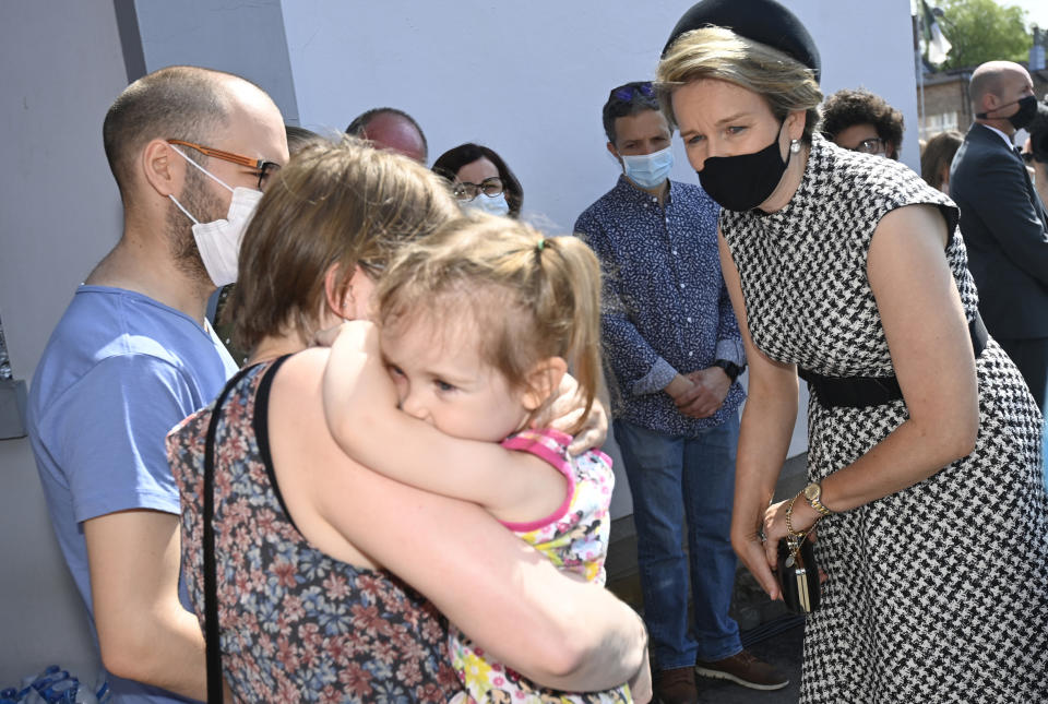 Belgium's Queen Mathilde, right, speaks with residents affected by the floods, prior to participating in a ceremony of one minute of silence to pay respect to victims of the recent floods in Belgium, in Verviers, Belgium, Tuesday, July 20, 2021. Belgium is holding a day of mourning on Tuesday to show respect to the victims of the devastating flooding last week, when massive rains turned streets in eastern Europe into deadly torrents of water, mud and flotsam. (Eric Lalmand, Pool Photo via AP)