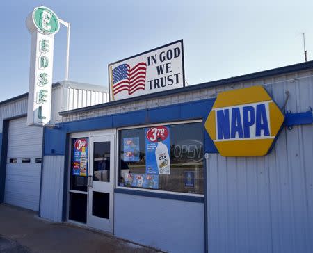 An auto parts store advertises the sign "In God We Trust" in Cisco, Texas, August 23, 2015. REUTERS/Mike Stone