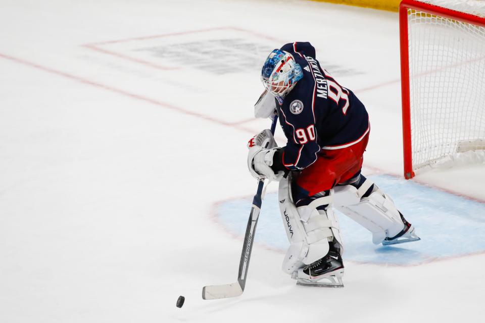 Columbus Blue Jackets goaltender Elvis Merzlikins (90) handles the puck during the second period of the NHL game against the Vancouver Canucks at Nationwide Arena in Columbus, Ohio Nov. 26.