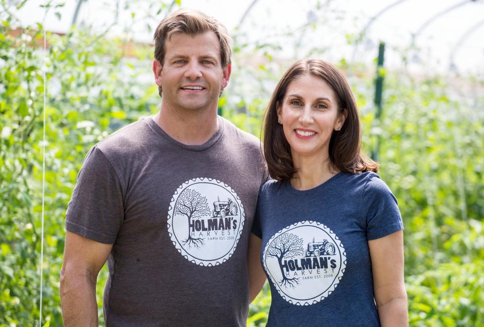 Marty and Liza Holman stand in their high tunnel greenhouse at Holman's Harvest farm in Loxahatchee Groves in April 2017.  