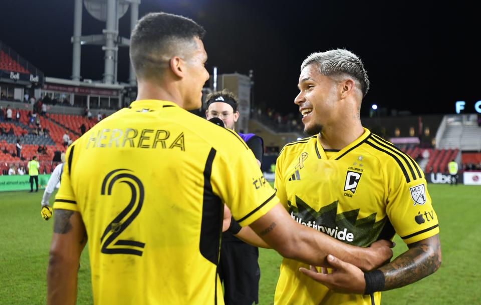 Sep 18, 2024; Toronto, Ontario, CAN; Columbus Crew forward Cucho Hernandez (9) and defender Andres Herrera (2) celebrate after a win over Toronto FC at BMO Field. Mandatory Credit: Dan Hamilton-Imagn Images