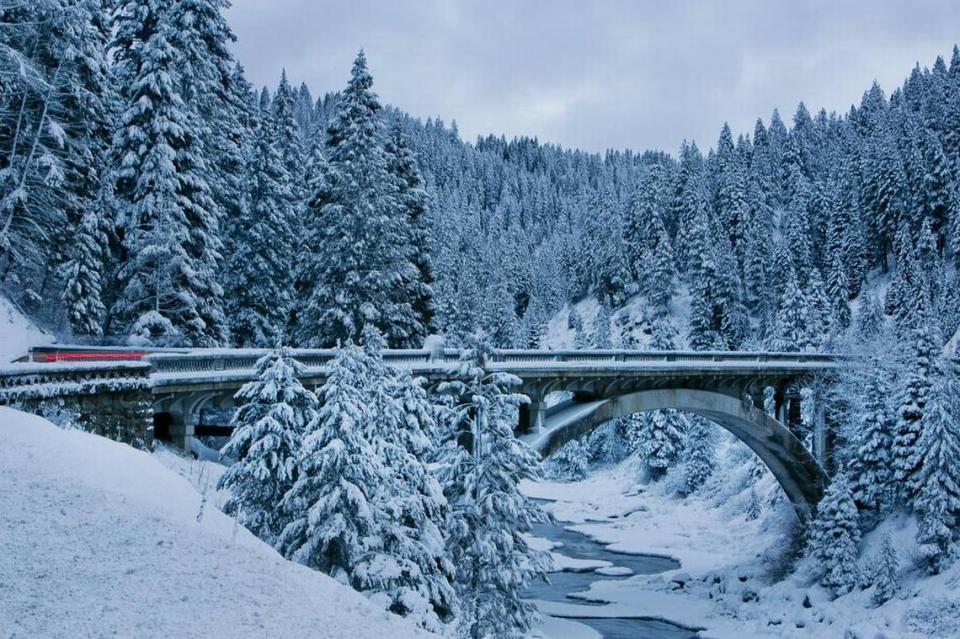 A fresh coating of snow covers the Rainbow Bridge and surrounding trees on Idaho State Highway 55 near Cascade, Idaho. According to the Idaho Transportation Department the Rainbow Bridge, which spans the Payette River between Smiths Ferry and Cascade was built in 1933 is the largest single-span concrete arch structure in Idaho. Thursday January 9, 2014 Kyle Green/kgreen@idahostatesman.com