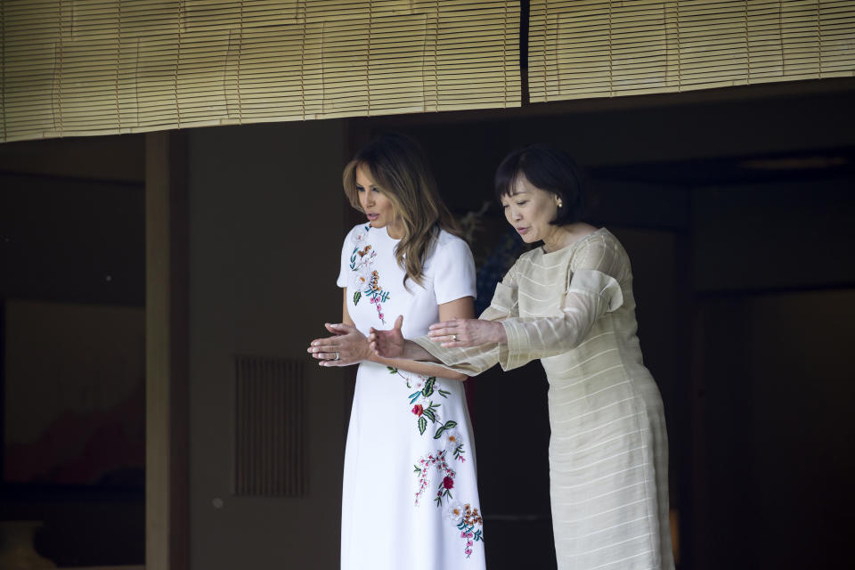 U.S. first lady Melania Trump, left, and Japanese Prime Minister Shinzo Abe's wife Akie Abe look at koi carps in a pond at the Japanese style annex inside the State Guest House in Tokyo Monday, May 27, 2019. (Tomohiro Ohsumi/Pool Photo via AP)