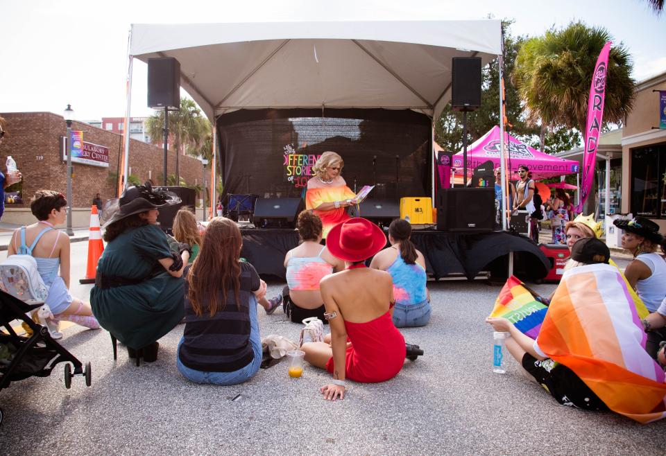 A drag queen reads a story on stage during the Space Coast Pride festival in downtown Melbourne.