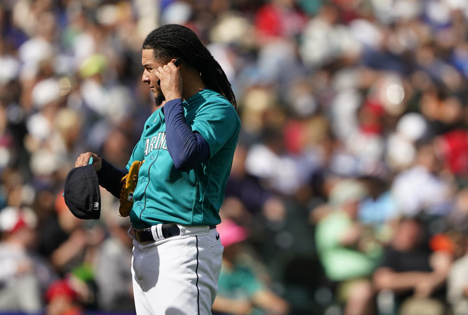 Seattle Mariners starting pitcher Luis Castillo holds up his PitchCom device to his ear during the fourth inning of a baseball game against the Los Angeles Angels, Wednesday, Sept. 13, 2023, in Seattle. (AP Photo/Lindsey Wasson)