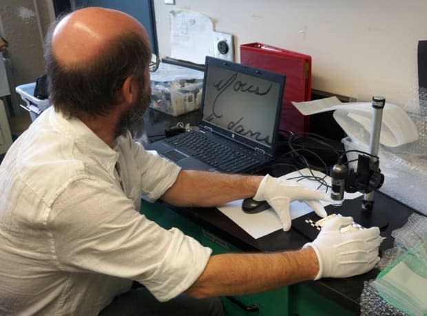 Nicolas Beaudry, a history and archaeology professor at the Université du Québec à Rimouski, examines the letter. 