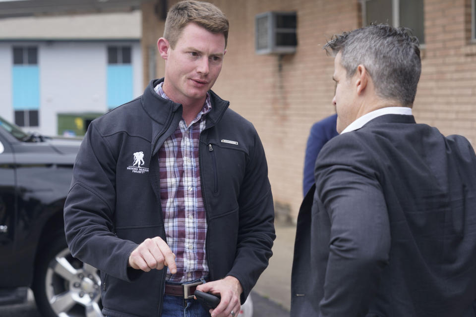 Texas congressional candidate Michael Wood, left, talks with Rep. Adam Kinzinger, R-Ill., Tuesday, April 27, 2021, in Arlington, Texas. Wood is considered the anti-Trump Republican Texas congressional candidate that Kinzinger has endorsed in the May 1st special election for the 6th Congressional District. (AP Photo/LM Otero)