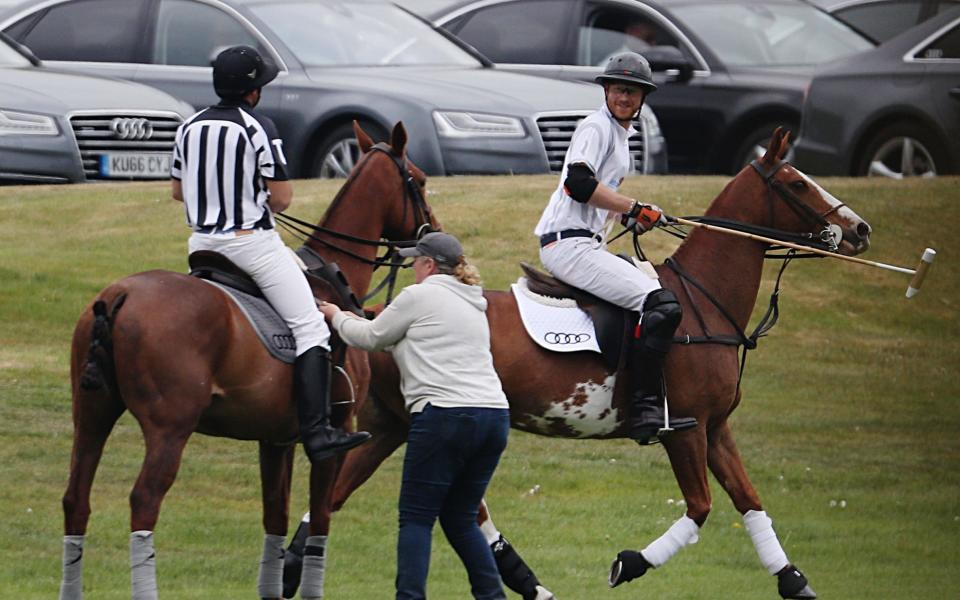 Prince Harry enjoys a moment during today's polo event - Credit: Steve Parsons/PA