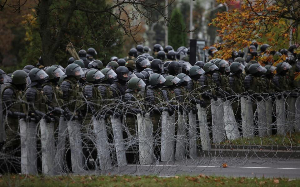 Belarusian service members stand guard during an opposition rally to reject the presidential election results - REUTERS