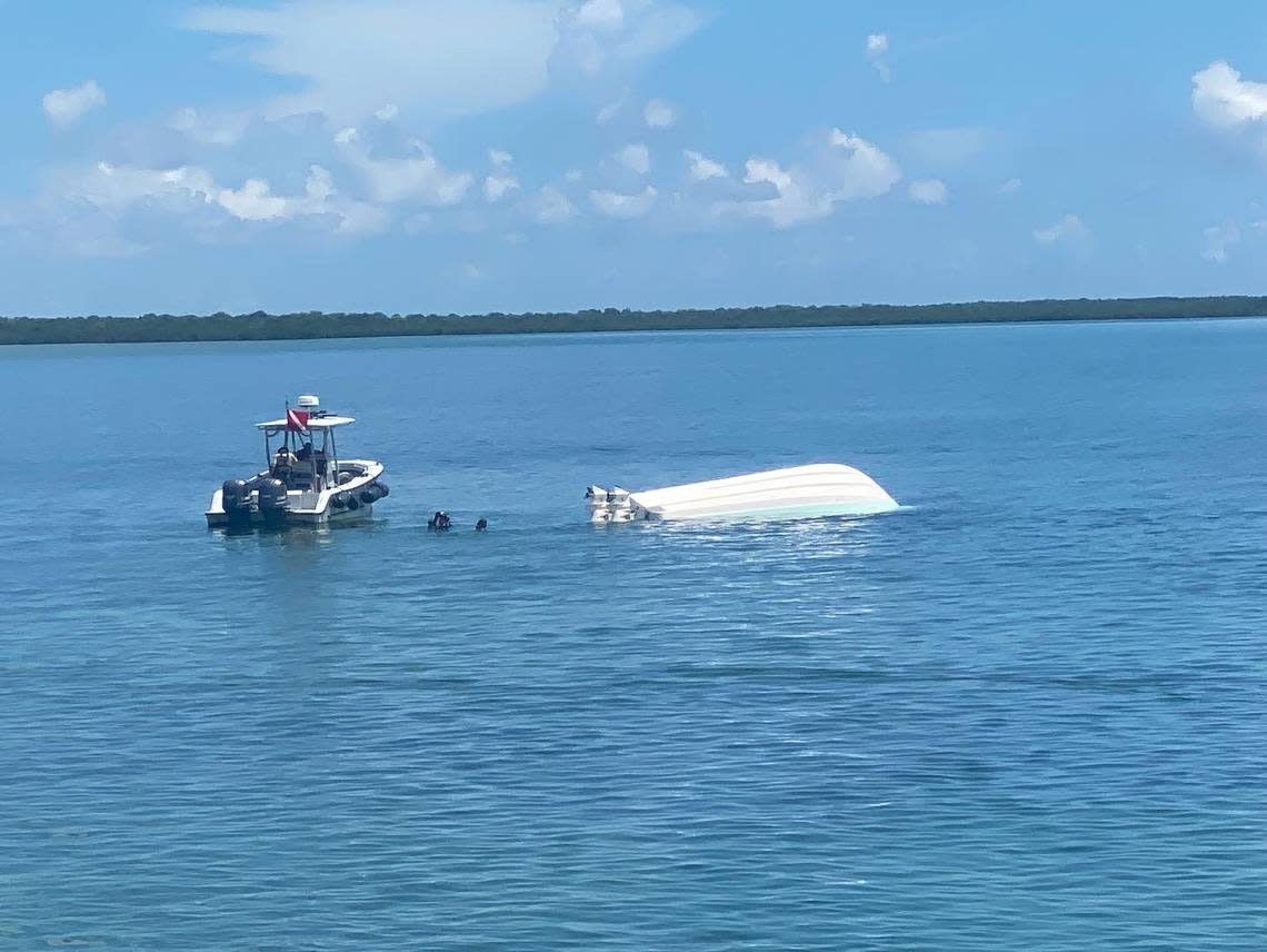 A rescue boat at the scene of the boat wreck in Biscayne Bay off North Key Largo on Sunday. Investigators with he Florida Fish and Wildlife Conservation Commission are still probing what caused the boat to strike a channel marker, which flipped the 29-foot Robalo and hurled everyone aboard into the water.