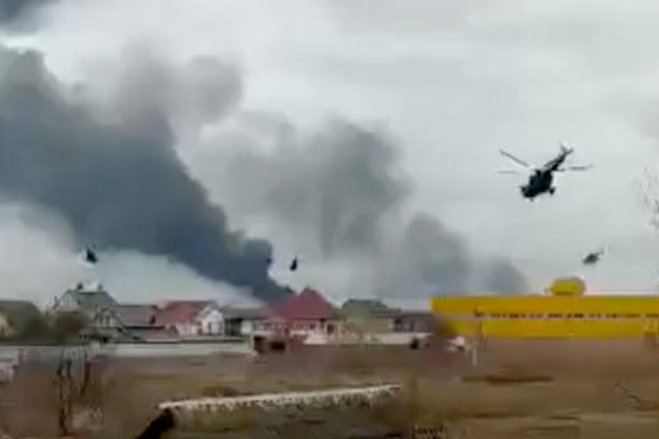 Helicopters fly toward Antonov Airport in Hostomel near the Ukrainian capital, Kyiv, on Thursday.