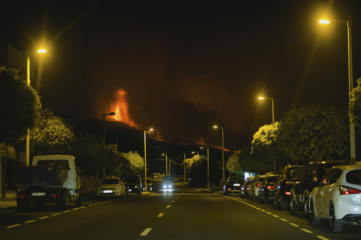 Lava flows from an eruption of a volcano near El Paso on the island of La Palma in the Canaries, Spain, in the early hours of Monday, Sept. 20, 2021. Lava continues to flow slowly from a volcano that erupted in Spain’s Canary Islands off northwest Africa. The head of the islands' regional government says Monday he expects no injuries to people in the area after some 5,000 were evacuated. (AP Photo/ Jonathan Rodriguez)