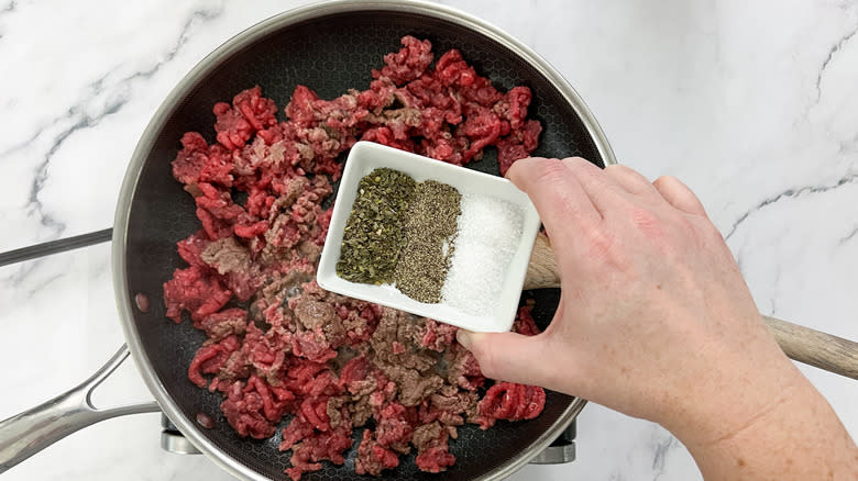 beef and seasoning in skillet