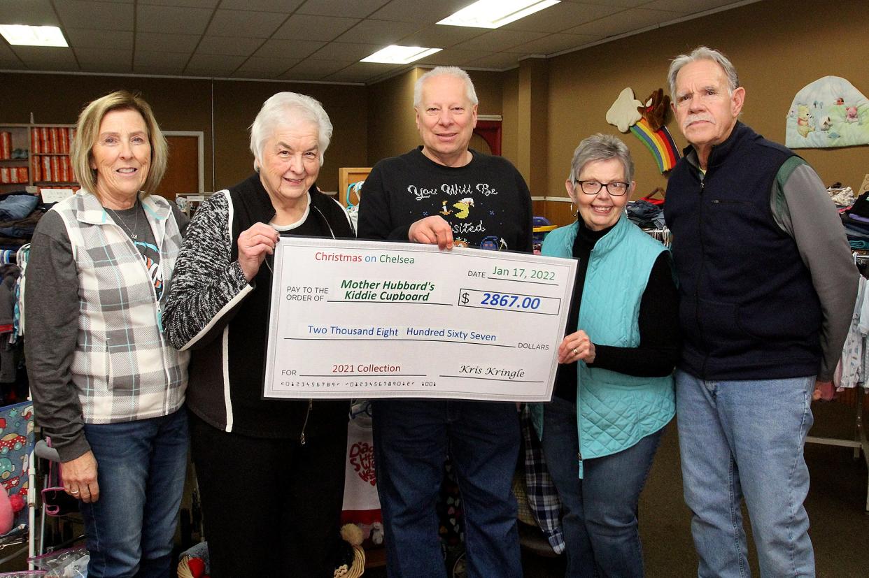 Ray Matthews, center, presents a check to members of the board of Mother Hubbard's Kiddie Cupboard, from left, Sally Wagner, Joanne Schamberger, Donna Frake and Bill Frake on Monday, Jan. 17, 2022, in Freeport. Funds were raised through donations to Christmas on Chelsea, an annual Christmas light display in the Freeport area.