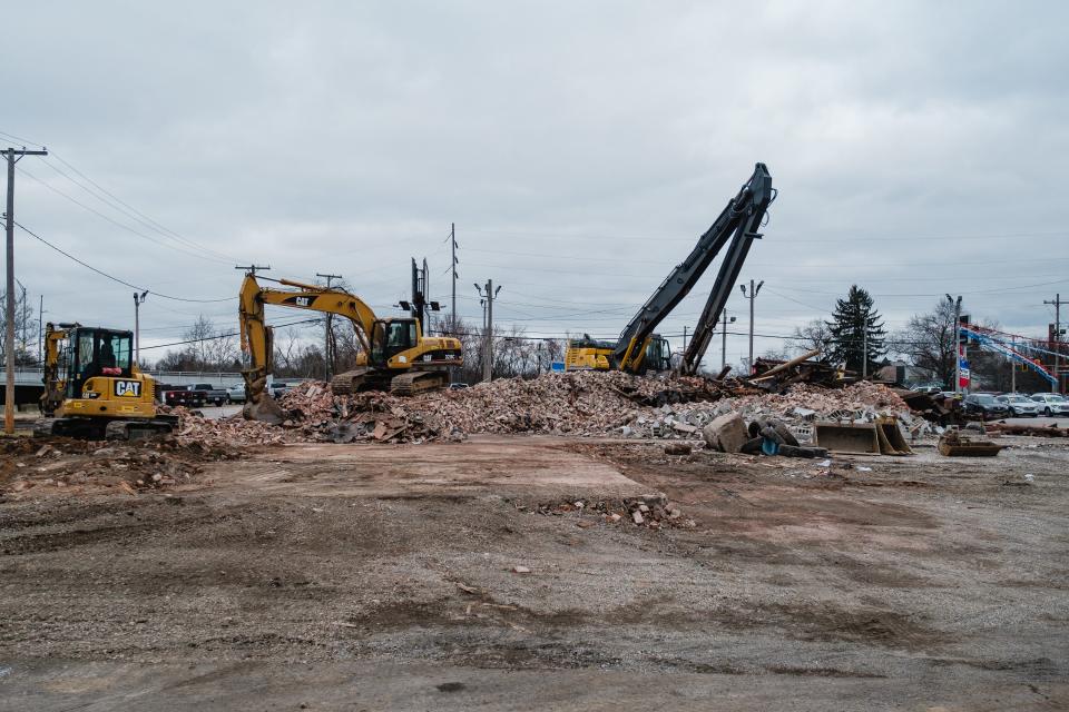 Crews work to clear rubble from the former Tuscarawas Valley Brewing Company once located at the corner of South Wooster Avenue and West Broadway Street in Dover, Thursday, Jan. 4.