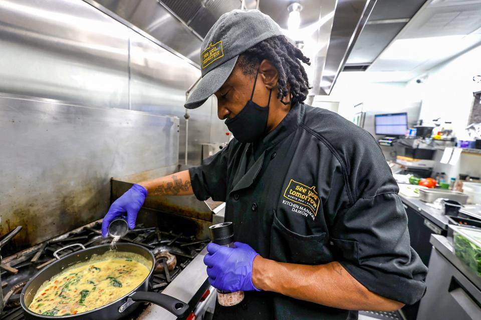 Damon Cann is the kitchen manager at See You Tomorrow, a restaurant on Woodward avenue in New Center Detroit, and works at scrambling eggs before they open at 8 a.m. on Wed., Nov 30, 2022.Cann was a cook at a Birmingham restaurant before coming to work at See You Tomorrow, not far from where he grew up.