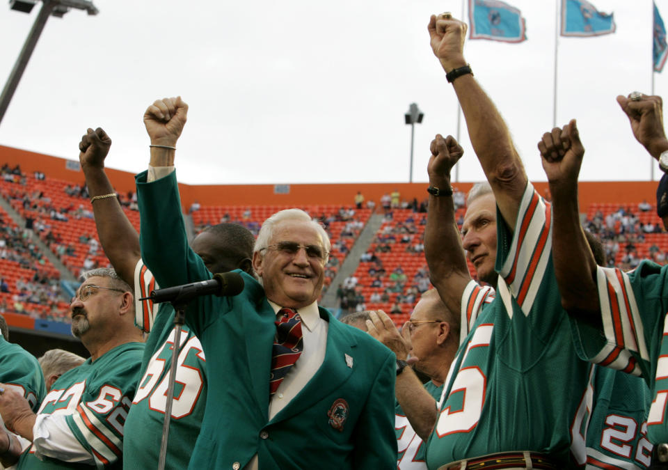 FILE - In this Dec. 16, 2007 file photo, former Miami Dolphins coach Don Shula, left, and player Nick Buoniconti, right, wave during a halftime ceremony honoring the 1972 perfect season of the Dolphins during an NFL football game against the Baltimore Ravens at Dolphin Stadium in Miami. Pro Football Hall of Fame middle linebacker Nick Buoniconti, an undersized overachiever who helped lead the Miami Dolphins to the NFL's only perfect season, has died at the age of 78. Bruce Bobbins, a spokesman for the Buoniconti family, said he died Tuesday, July 30, 2019, in Bridgehampton, N.Y. (AP Photo/Lynne Sladky, File)