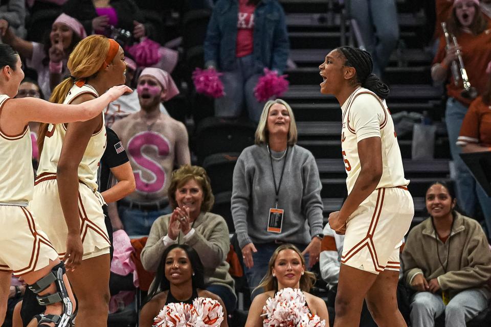 Texas point guard Madison Booker, right, and forward Aaliyah Moore, left, celebrate a blocked shot during the Longhorns' win over Iowa State on Feb. 17. Booker, who arrived this past offseason as a five-star freshman forward, has thrived after being pressed into point guard duties following Rori Harmon's injury.