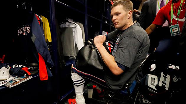 Brady frantically searches for the jersey. Image: Getty