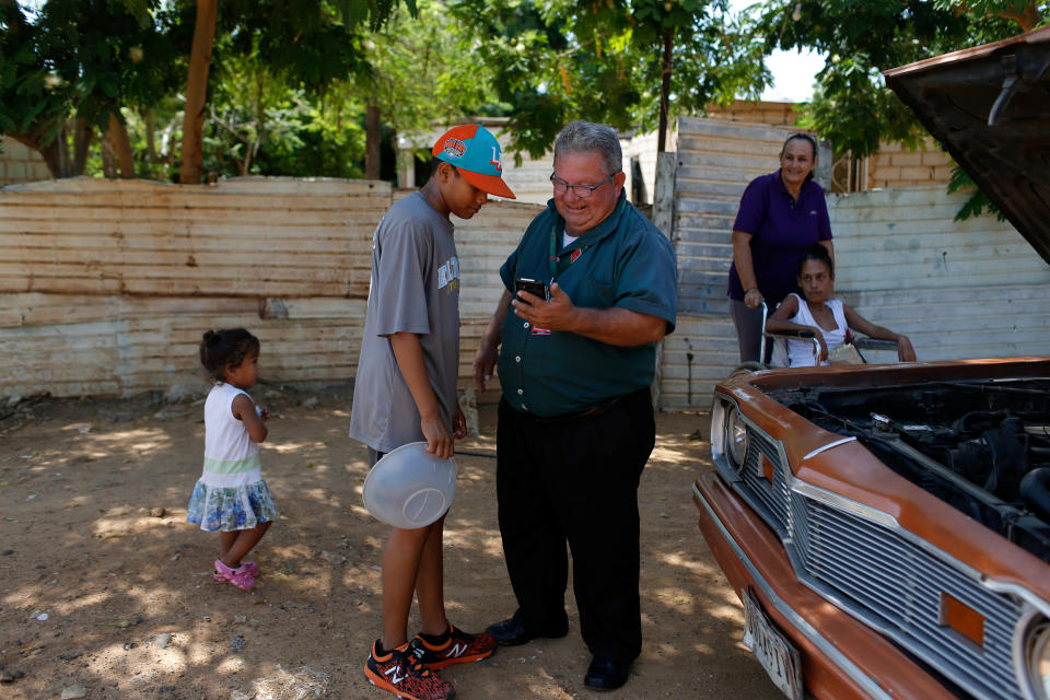 Baseball little league player Adrian Salcedo, 13, talks with a neighbor at 19 de Abril slum, where he lives, in Maracaibo, Venezuela. (Photo: Manaure Quintero/Reuters)
