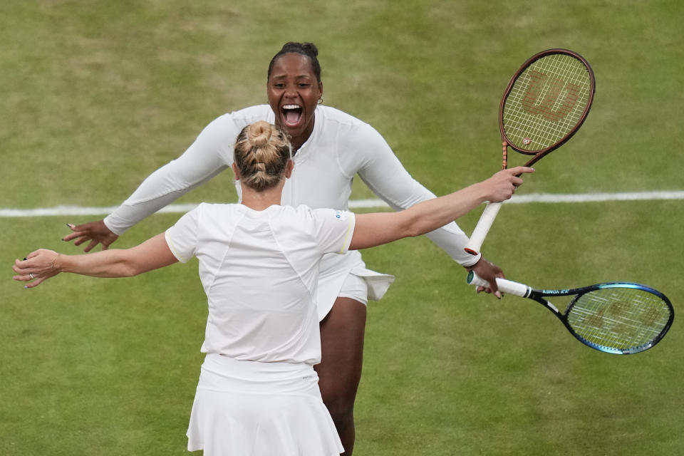 Taylor Townsend, top, of the United States and Katerina Siniakova of the Czech Republic and celebrate after defeating Gabriela Dabrowski of Canada and Erin Routliffe of New Zealand in the women's doubles final at the Wimbledon tennis championships in London, Saturday, July 13, 2024. (AP Photo/Kirsty Wigglesworth)