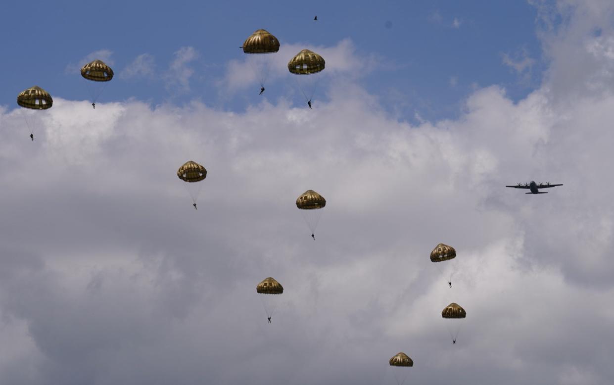 Members of the British, Belgian, Canadian and US military take part in a parachute jump display organised by the Royal Air Force and British Army over 'Drop Zone K', near Sannerville, France