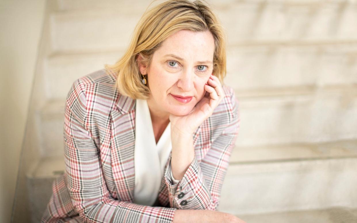 A portrait shot of Amber Rudd wearing a plaid jacket