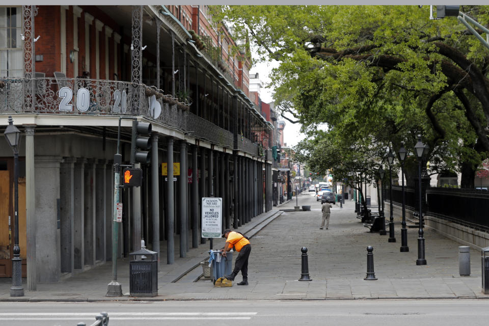 A worker rests alongside Jackson Square in the French Quarter of New Orleans, normally bustling with tourists, but now nearly deserted due to the new coronavirus pandemic, Friday, March 27, 2020. While rich in history and culture, New Orleans is economically poor, and the people here are not necessarily well-positioned to weather this latest storm. (AP Photo/Gerald Herbert)