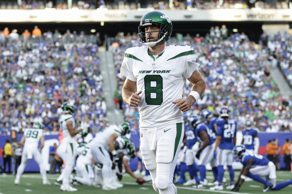 New York Jets quarterback Aaron Rodgers (8) runs off the field during the first half of an NFL preseason football game against the New York Giants, Saturday, Aug. 26, 2023, in East Rutherford, N.J. (AP Photo/Adam Hunger)