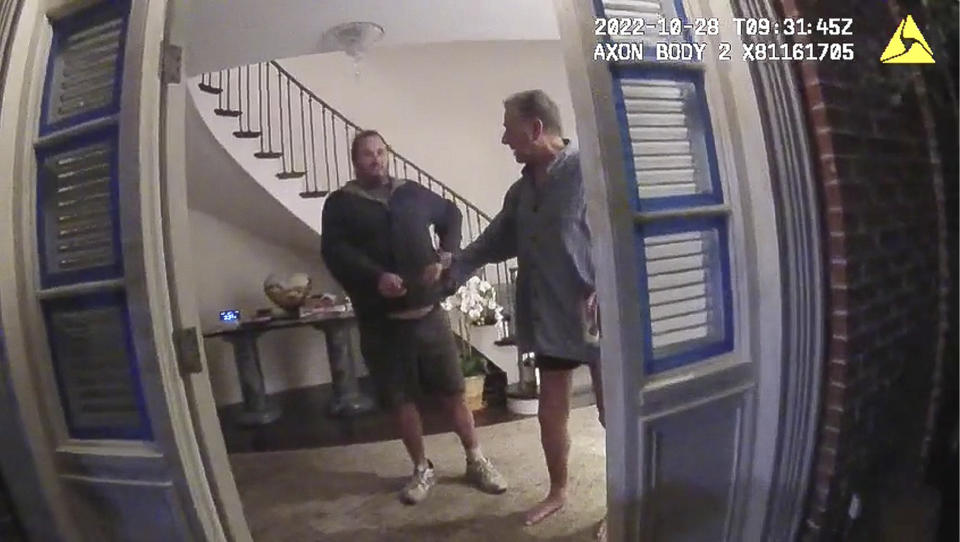 This image from video from police body-worn camera footage, released by the San Francisco Police Department, shows Paul Pelosi, right, fighting for control of a hammer with his assailant, David DePape, during a attack at Pelosi's home in San Francisco on Oct. 28, 2022. DePape wrests the tool from Pelosi and lunges toward him the hammer over his head. The blow to Pelosi occurs out of view of the video as officers rush into the house and subdue DePape. (San Francisco Police Department via AP)