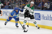 FILE - In this Feb. 8, 2020, file photo, Dallas Stars' Miro Heiskanen (4), of Finland, passes around St. Louis Blues' Jaden Schwartz (17) during the second period of an NHL hockey game in St. Louis. This is a Stanley Cup matchup for all of those who like their games to be a bit defensive. The Stars and the Tampa Bay Lightning, two of the league's southernmost teams playing for the title in a bubble at the NHL's most northern arena in Edmonton, both have defensemen who provide plenty of points. (AP Photo/Jeff Roberson, File)