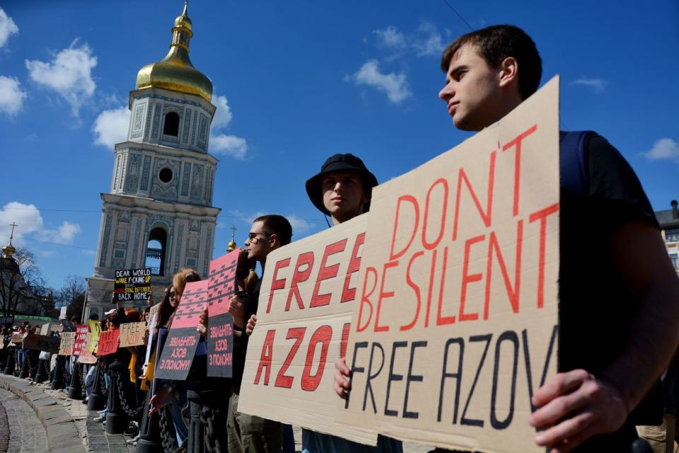 Activists and relatives of Ukrainian prisoners of war hold banners urging for the return of Ukrainian soldiers of Mariupol garrison from Russian captivity during the rally on Sophia Square in Kyiv, Ukraine on April 7, 2024. The Free Azov rally in support of the captured defenders of Mariupol was held in Kyiv and other Ukrainian cities. The participants came out to remind Ukrainian society that Ukrainian soldiers have been in Russian captivity for the second year. (Oleksandr Gusev/Global Images Ukraine via Getty Images)