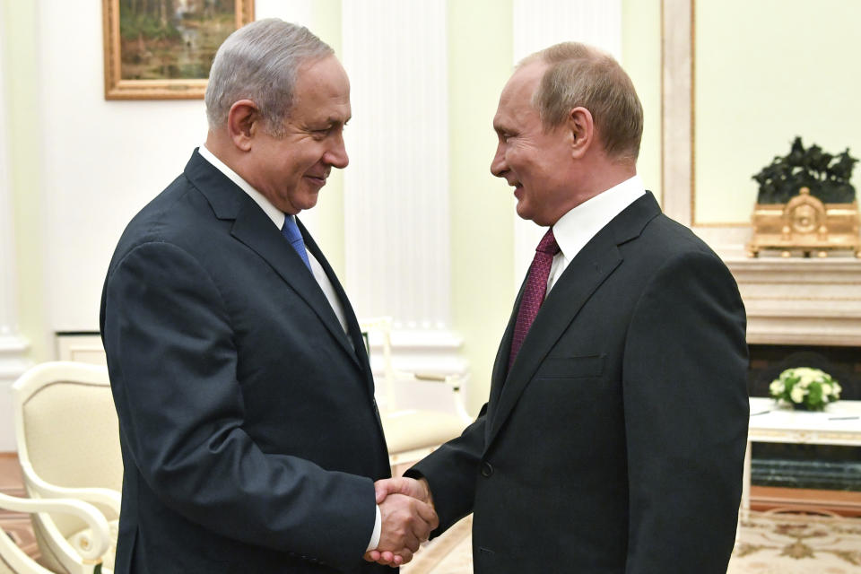 FILE - In this July 11, 2018, file photo, Russian President Vladimir Putin, right, shakes hands with Israeli Prime Minister Benjamin Netanyahu during their meeting at the Kremlin in Moscow. Netanyahu is one of the few world leaders to enjoy warm ties with both the Russian and American presidents. Netanyahu has made frequent visits to Moscow in recent years to meet with Putin and coordinate Israeli operations in neighboring Syria with those of Russian forces. (Yuri Kadobnov/ Pool Photo via AP, File)