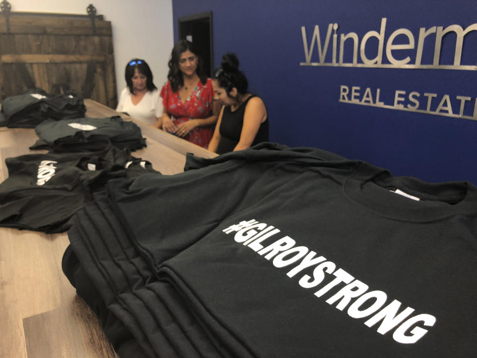 Employees and volunteers at Windermere Real Estate work at selling "#Gilroy Strong" T-shirts, with proceeds benefiting shooting victims, in Gilroy, Calif., Tuesday, July 30, 2019. Gilroy is the latest U.S. community to vow that a gunman wouldn't tear them down. A shooter killed two children and a 25-year-old from upstate New York at the Gilroy Garlic Festival this past weekend. People in the rural community known for growing garlic have raised their voices in the defiant cry of "Gilroy Strong" as authorities seek a motive for the killings. (AP Photo/Haven Daley)